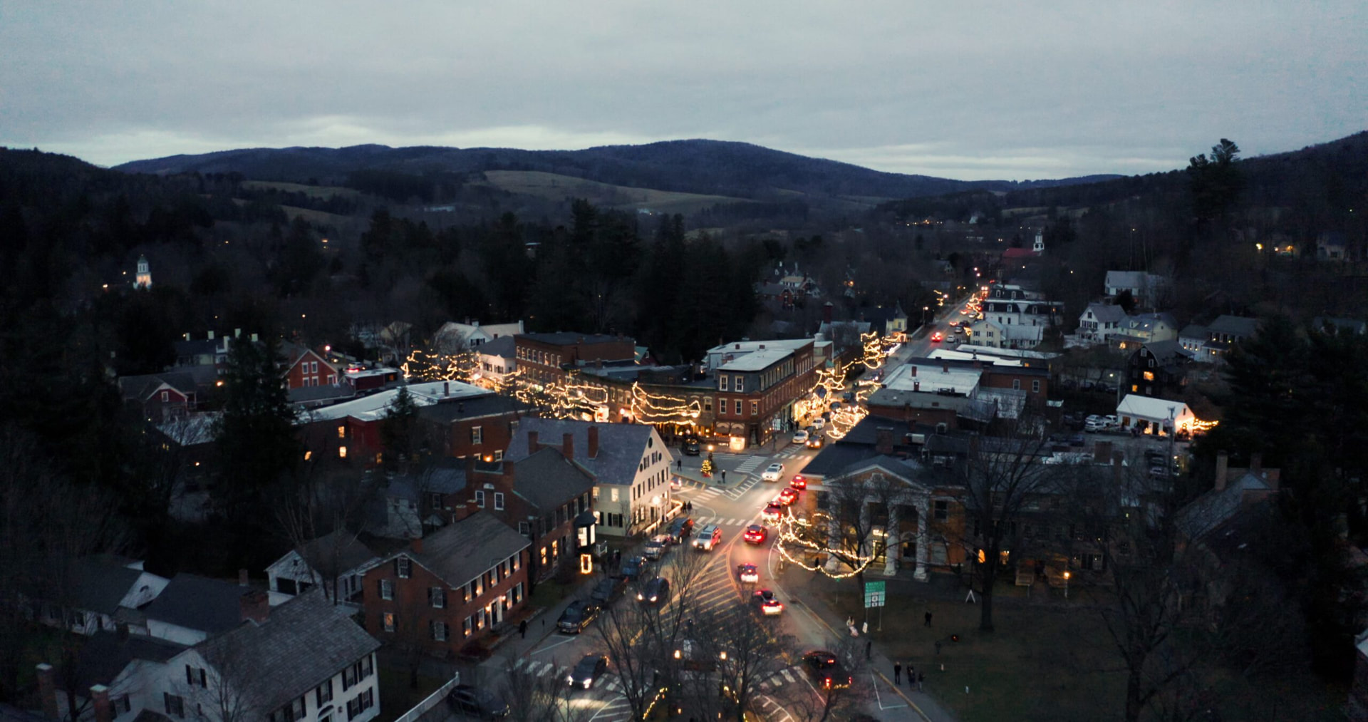 Aerial view of Woodstock village decorated for Wassail Weekend at dusk