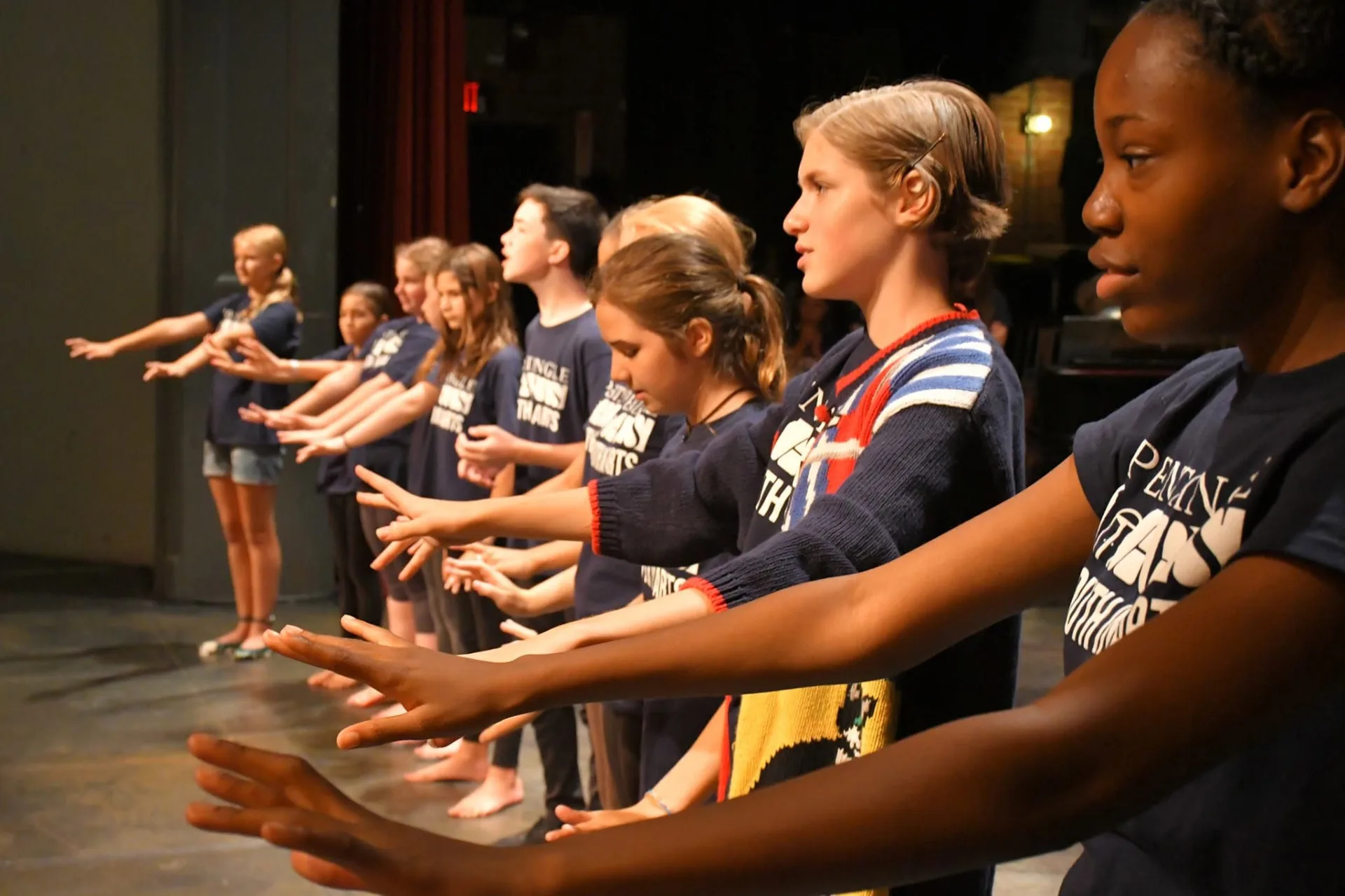 Young performers on the Town Hall Theatre stage during a rehearsal
