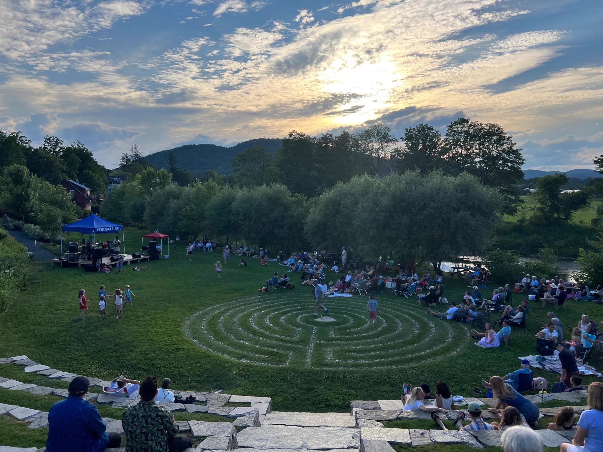 Neighbors gathered by the river for a Pentangle summer concert.