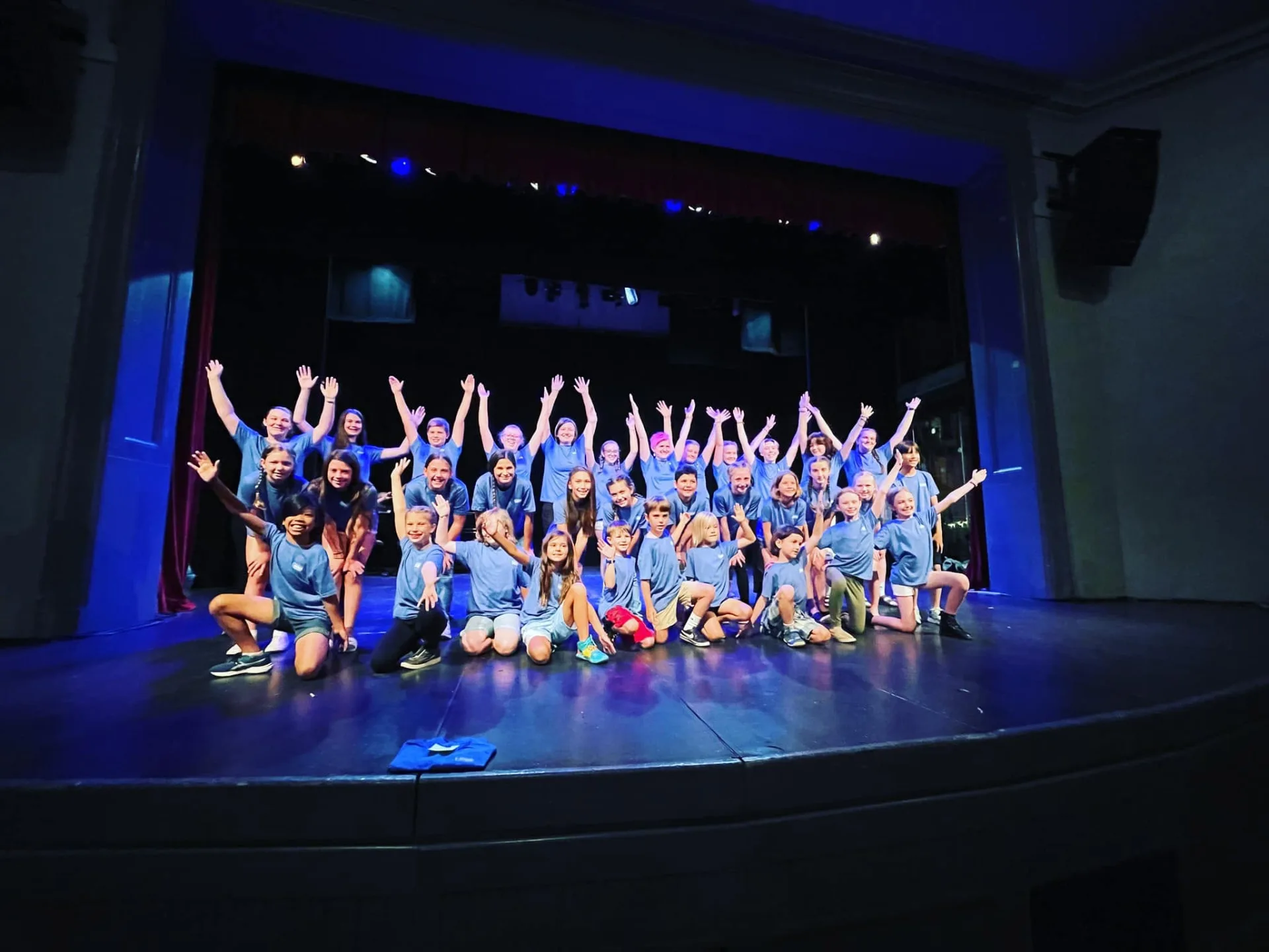 Summer Youth Theatre participants gathered together on stage after a performance