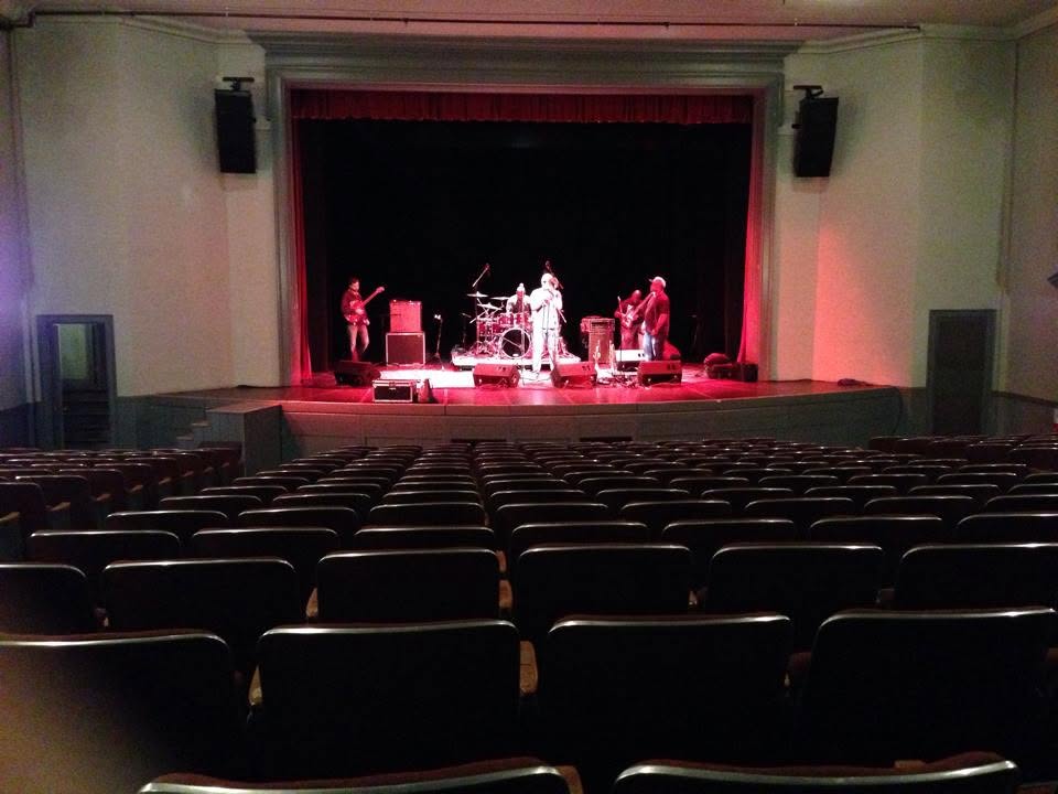 View across the Woodstock Town Hall Theatre auditorium toward the stage.