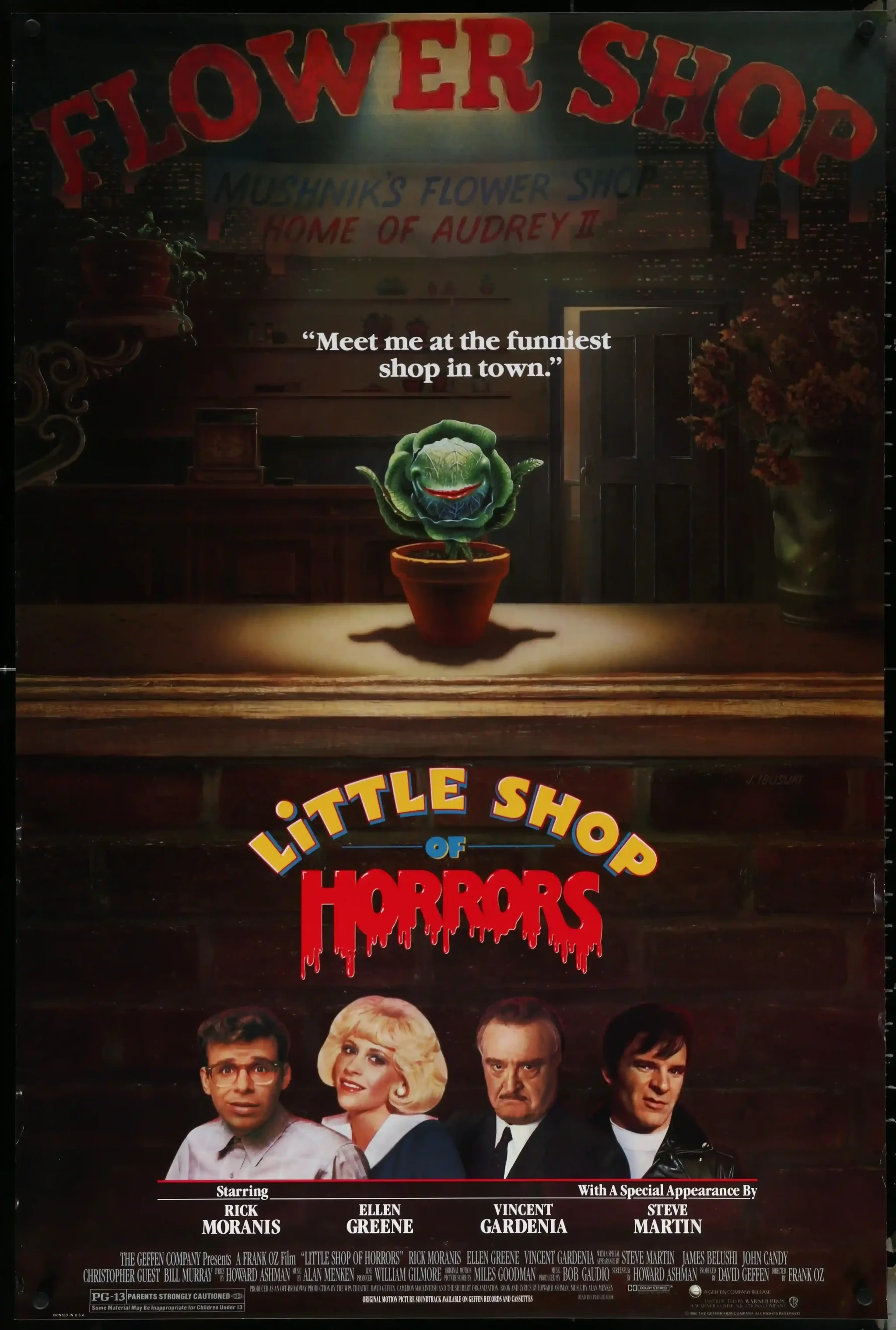 Little Shop of Horrors poster showing Audrey II in a flower shop beneath a spotlight, with the film’s four principal cast members pictured below.