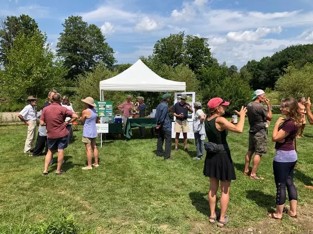 Community members gather outdoors at a Sustainable Woodstock event.